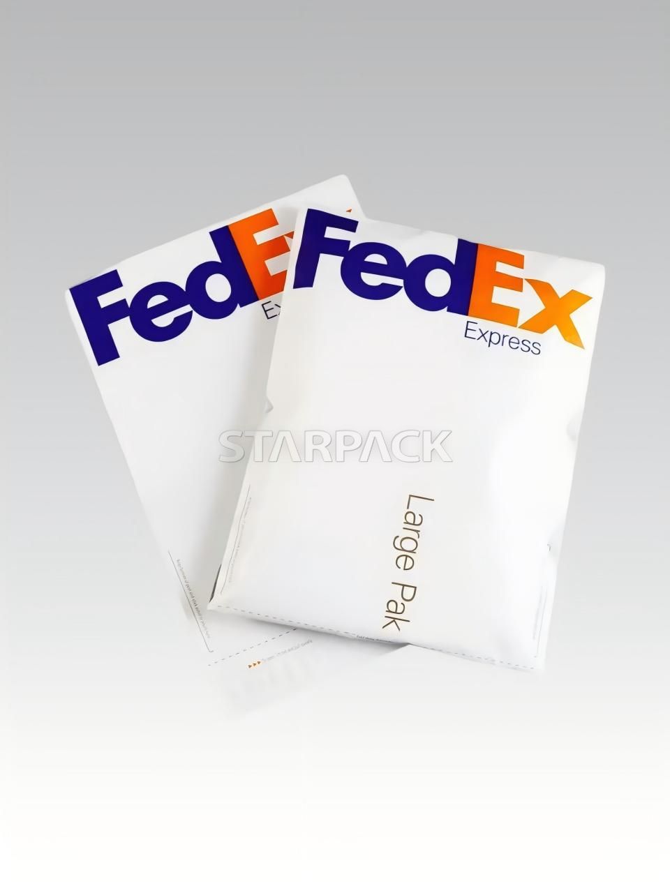 Two stacked FedEx Express Large Pak plastic courier envelopes with official logo
