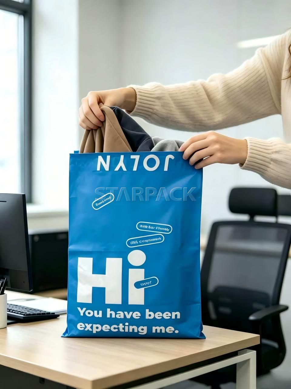 Office scene photo staff holding custom printed blue fully compostable PLA shipping mailer bag, home compost eco plastic-free express packaging for e-commerce clothing parcel delivery