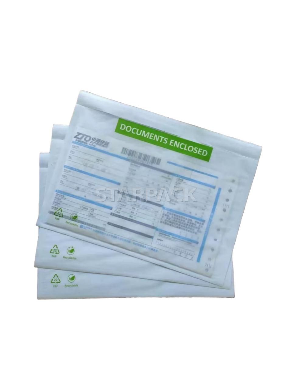 Two overlapped eco kraft paper self-adhesive invoice pouches printed green DOCUMENTS ENCLOSED label, compostable paper waybill holder for carton logistics shipping document packaging